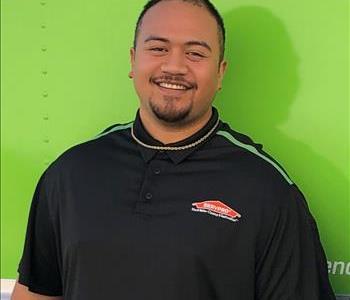 Crew Chief in front of green Servpro truck